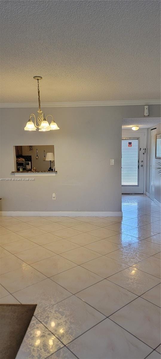 2840 Somerset Dr Unit 318M, Lauderdale Lakes, FL 33311 - spare room featuring tile patterned flooring, crown molding, baseboards, a textured ceiling, and a notable chandelier