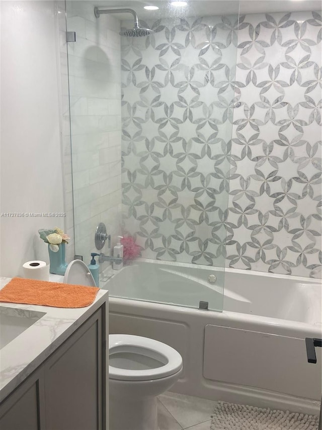 full bathroom featuring toilet, vanity, shower / bathtub combination, and tile patterned flooring