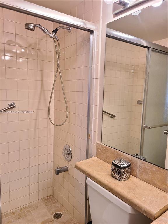 bathroom featuring an enclosed shower and toilet