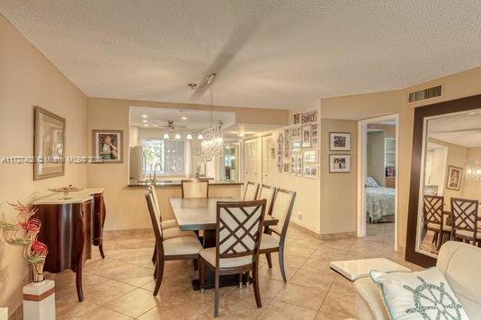 tiled dining space featuring a textured ceiling