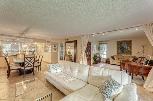 living room with a textured ceiling and track lighting