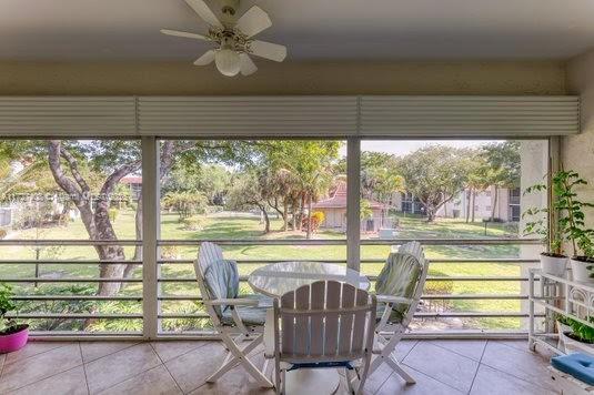 sunroom / solarium featuring ceiling fan