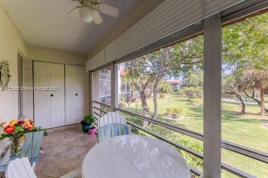 sunroom / solarium featuring ceiling fan