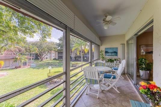 sunroom / solarium with ceiling fan