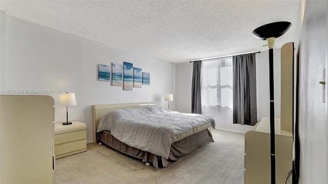 bedroom with carpet and a textured ceiling