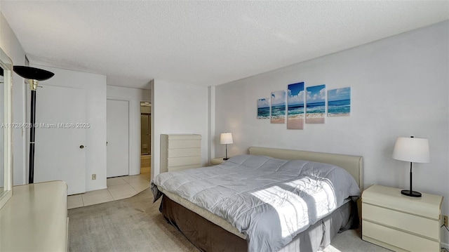 bedroom with light tile patterned flooring and a textured ceiling