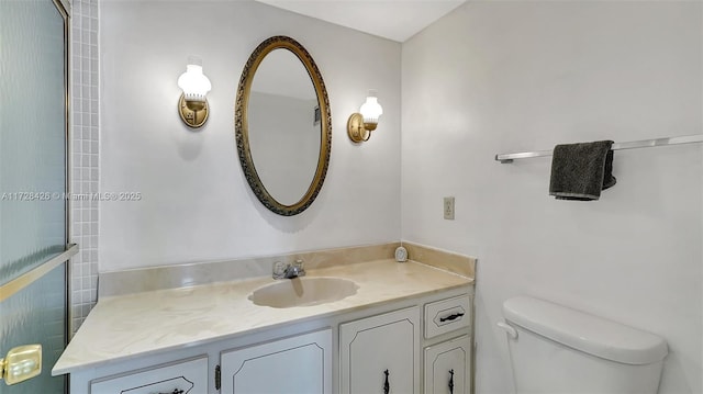 bathroom featuring toilet and vanity