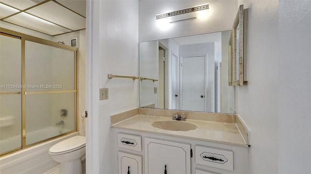 full bathroom featuring toilet, vanity, tile patterned flooring, and shower / bath combination with glass door