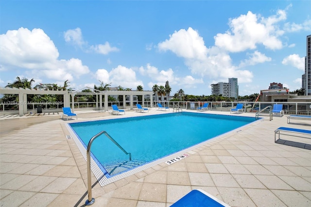 view of swimming pool featuring a patio area