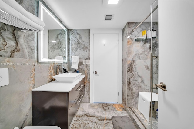 bathroom with walk in shower, vanity, and tile walls