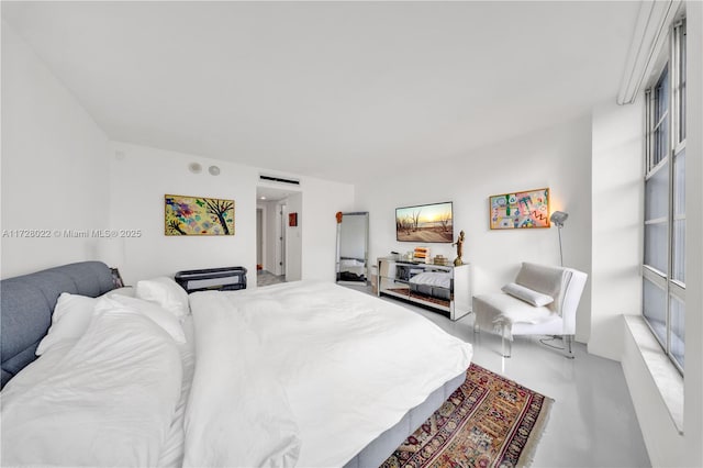 bedroom featuring concrete floors