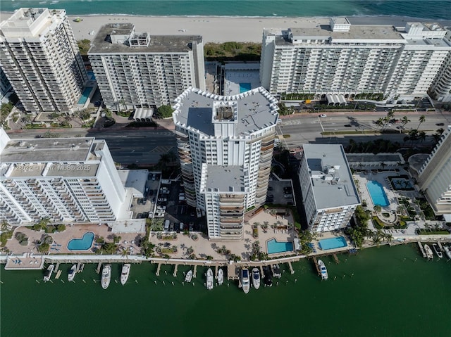 drone / aerial view featuring a water view and a beach view