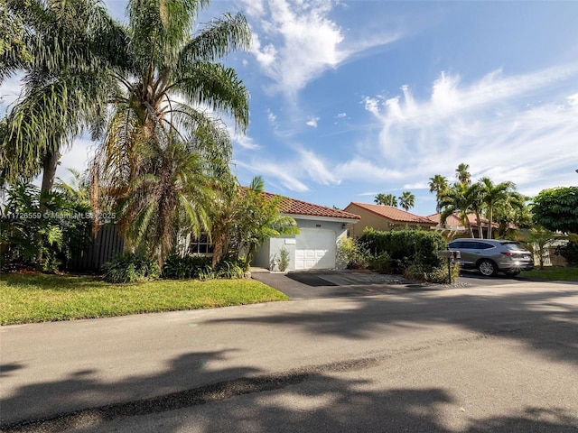 mediterranean / spanish-style home with a garage