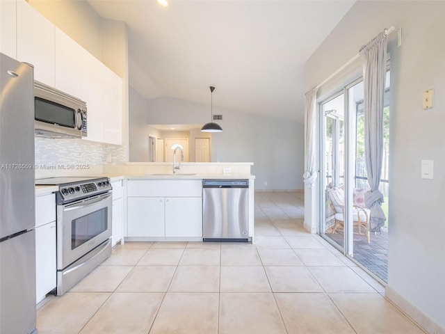 kitchen with appliances with stainless steel finishes, sink, white cabinets, and decorative light fixtures