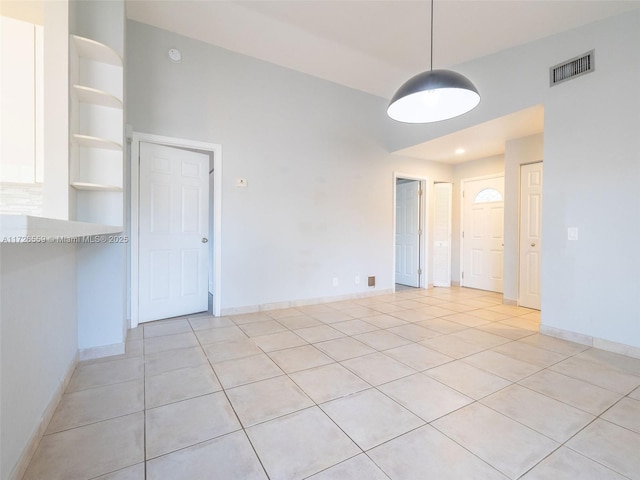 tiled empty room featuring built in features