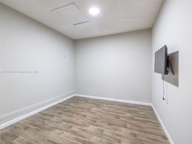 empty room with hardwood / wood-style flooring and a textured ceiling