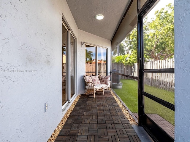 unfurnished sunroom featuring vaulted ceiling