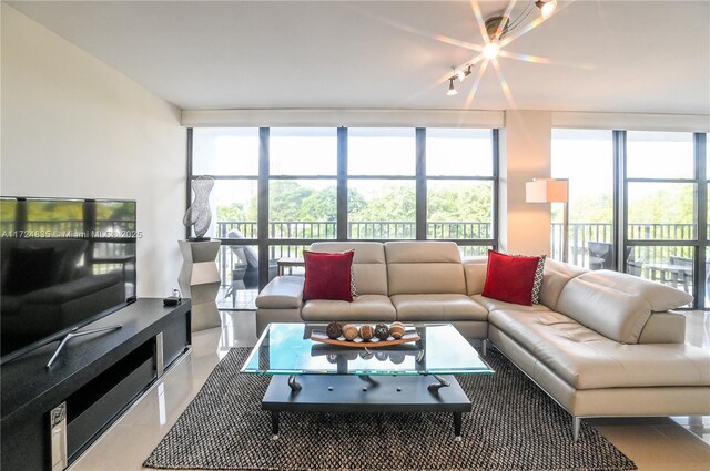 living room with tile patterned flooring, floor to ceiling windows, and plenty of natural light