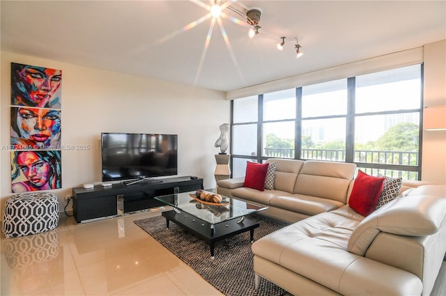 living room with floor to ceiling windows, a healthy amount of sunlight, and tile patterned flooring