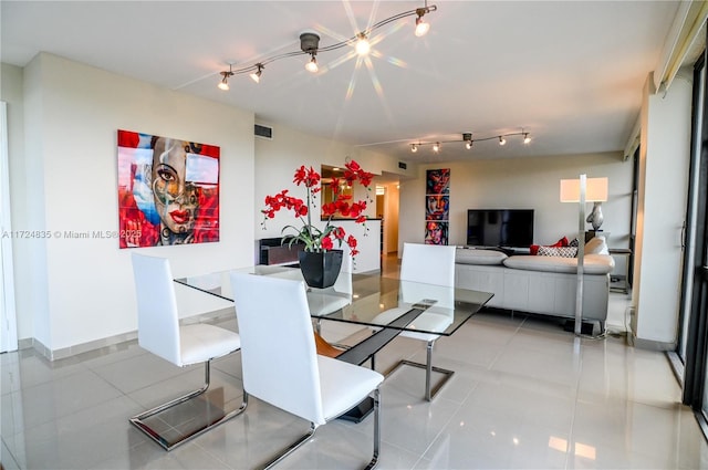 dining area with an inviting chandelier and light tile patterned floors