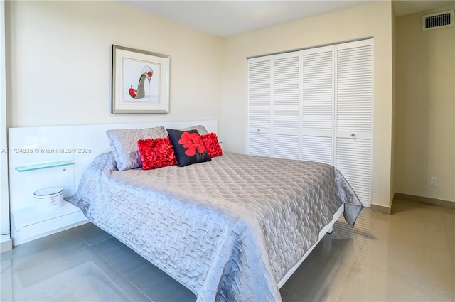 tiled bedroom with a closet