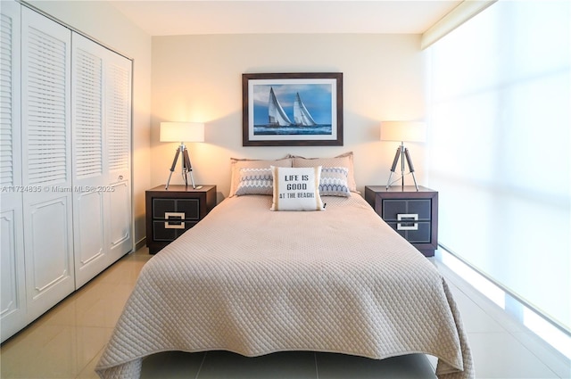 tiled bedroom with a closet