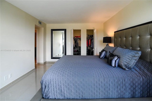 bedroom featuring a walk in closet and a closet