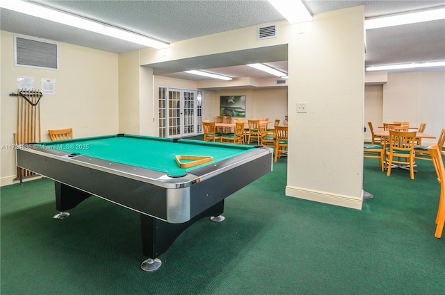 playroom featuring pool table, dark carpet, and a textured ceiling