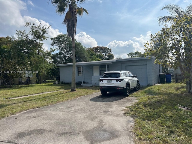 view of front of house with a front yard and a garage