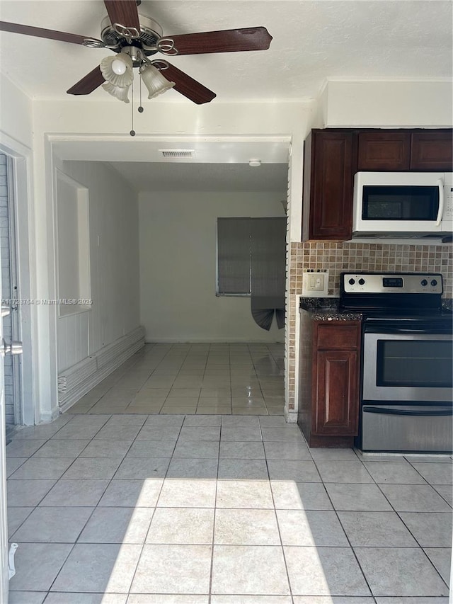 kitchen featuring ceiling fan, light tile patterned floors, stainless steel electric range oven, and tasteful backsplash