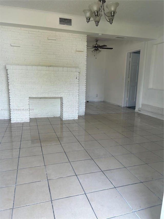 unfurnished living room featuring ceiling fan with notable chandelier, a brick fireplace, and light tile patterned flooring