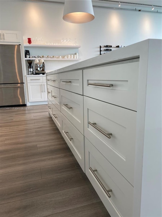 kitchen with white cabinets, stainless steel fridge, and dark hardwood / wood-style floors