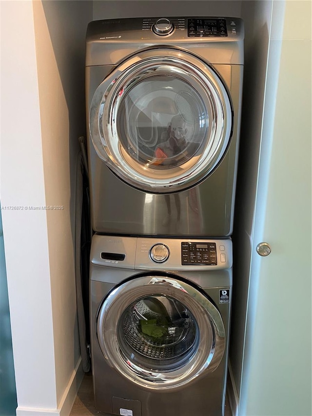 laundry room with stacked washer / drying machine