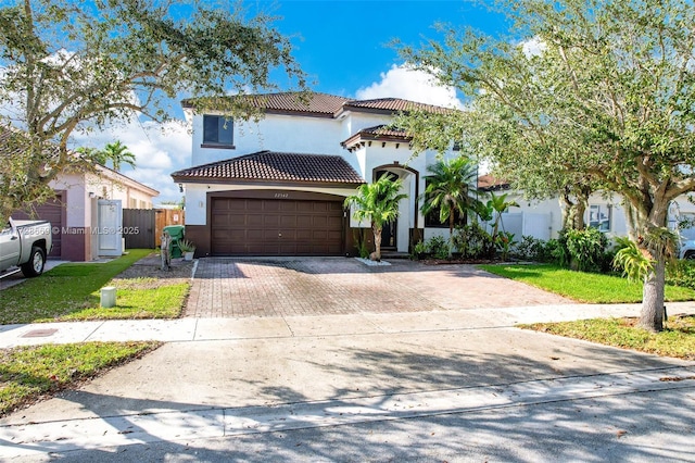 mediterranean / spanish-style house with a front yard and a garage