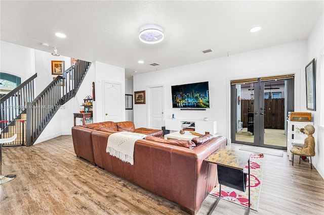 living room featuring wood-type flooring and french doors