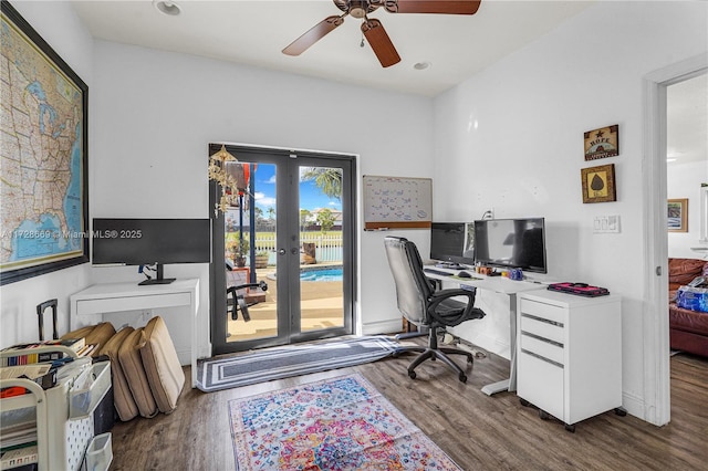 office with ceiling fan, dark hardwood / wood-style flooring, and french doors