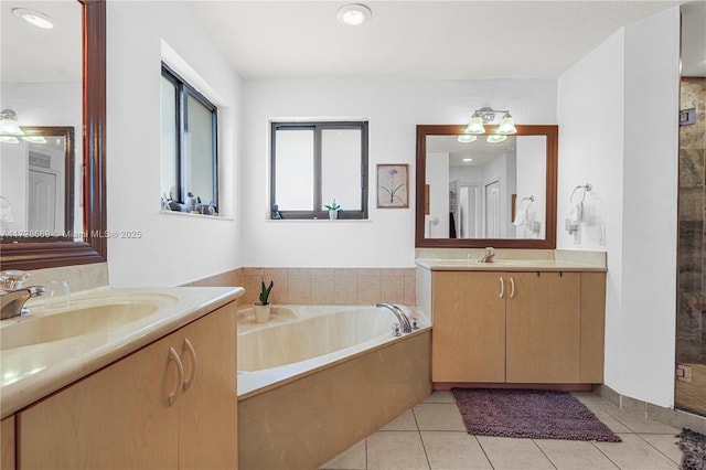 bathroom with a bath, tile patterned flooring, and vanity