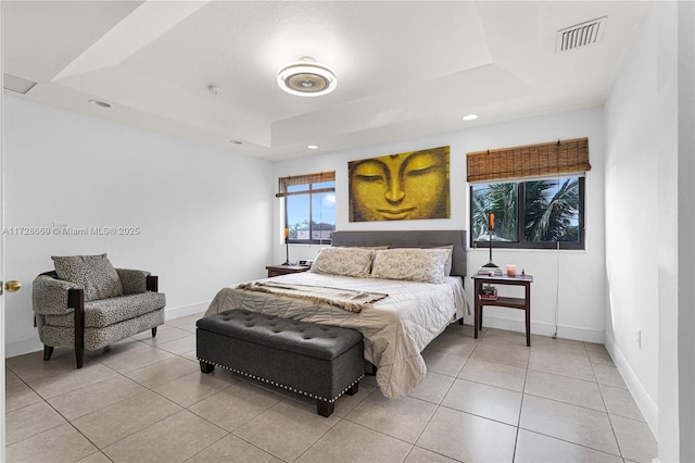 tiled bedroom featuring a tray ceiling