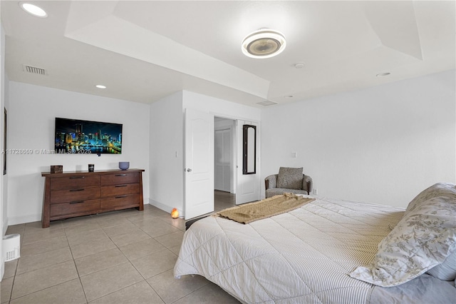 tiled bedroom with a raised ceiling