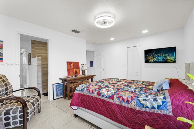 bedroom with light tile patterned floors, visible vents, recessed lighting, and a closet
