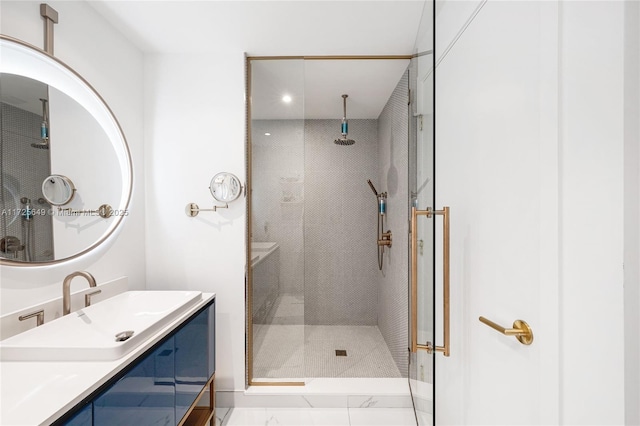 bathroom featuring vanity and a shower with door