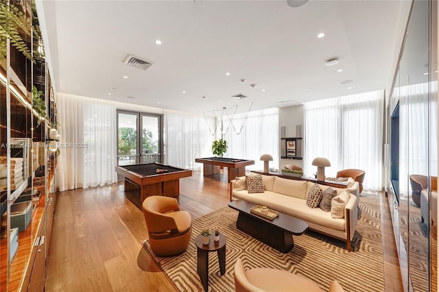 recreation room featuring a wall of windows, pool table, and light hardwood / wood-style floors