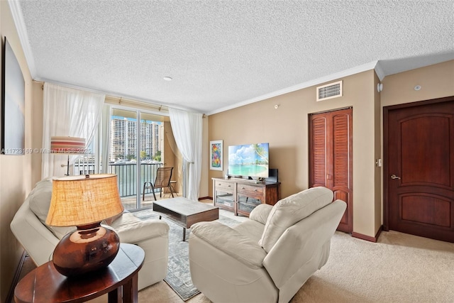 living room featuring light carpet, ornamental molding, a textured ceiling, and visible vents