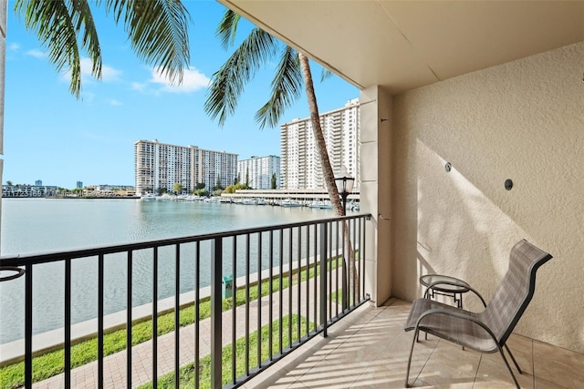 balcony with a view of city and a water view