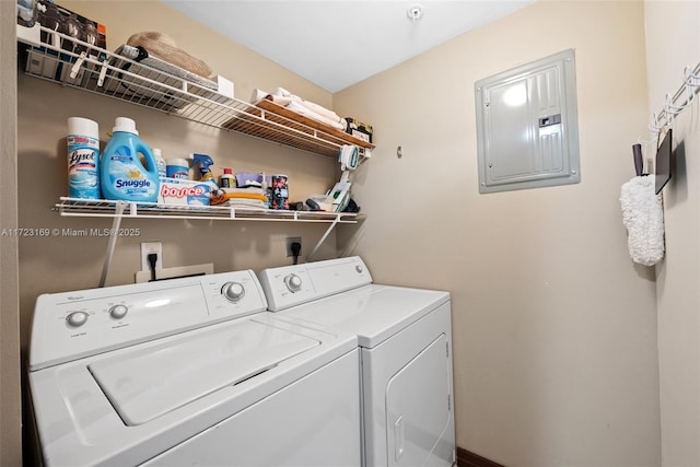 laundry room featuring laundry area, electric panel, and washer and clothes dryer