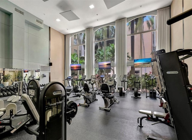 workout area featuring visible vents and a wall of windows