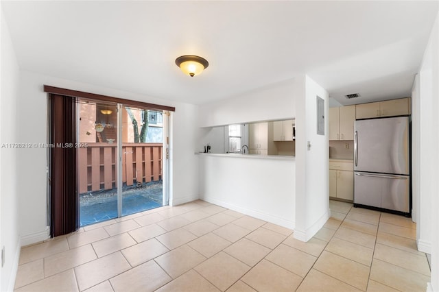 unfurnished room featuring light tile patterned floors