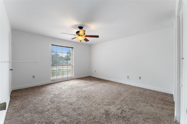 empty room featuring carpet floors and ceiling fan