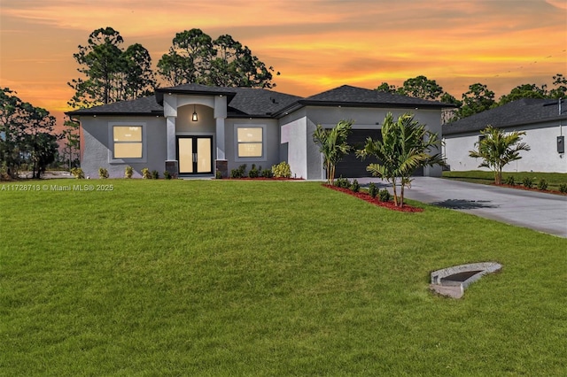 view of front of property with a lawn and a garage