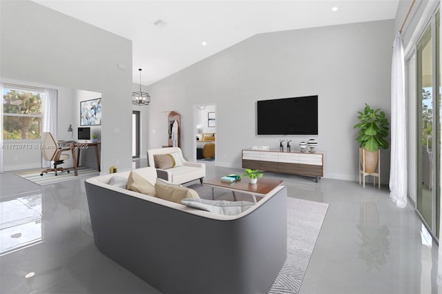 living room featuring high vaulted ceiling and an inviting chandelier